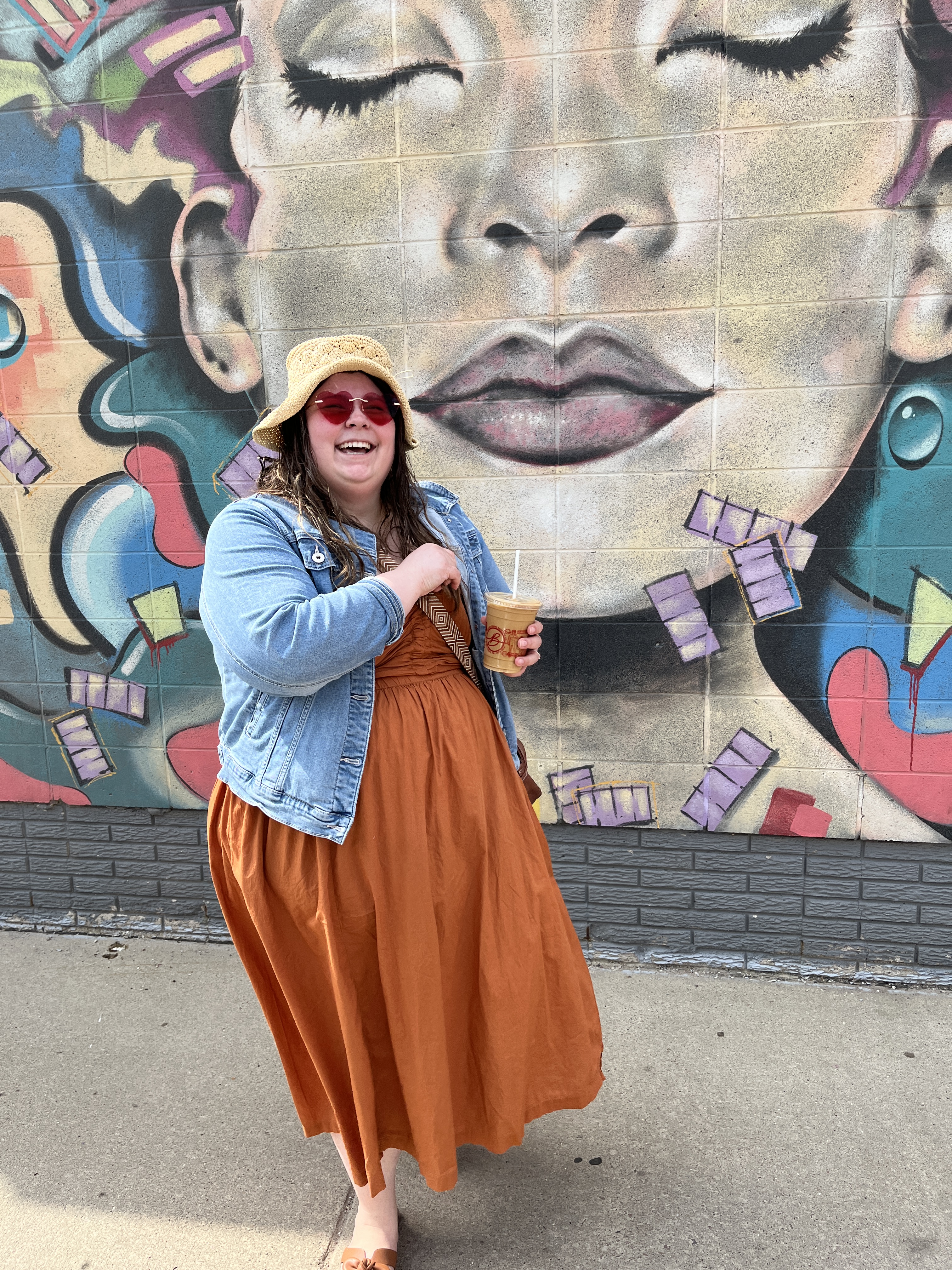Nicole Loe in front of a mural in downtown Sioux Falls
