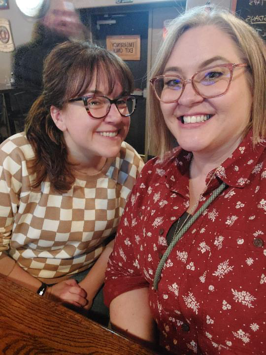Natasha and Local Lou sitting at a bar.