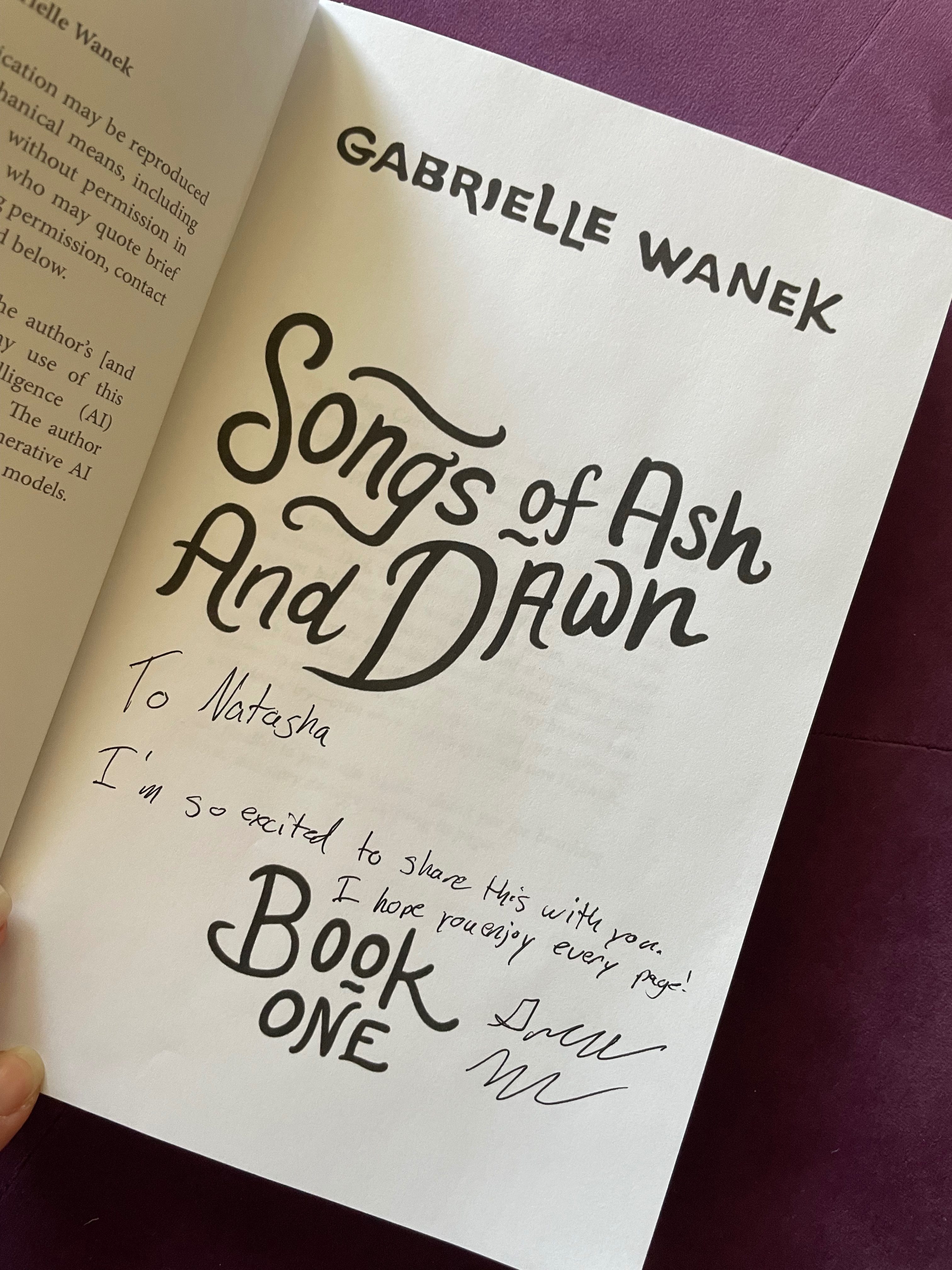 a signed copy of Songs of Ash and Dawn